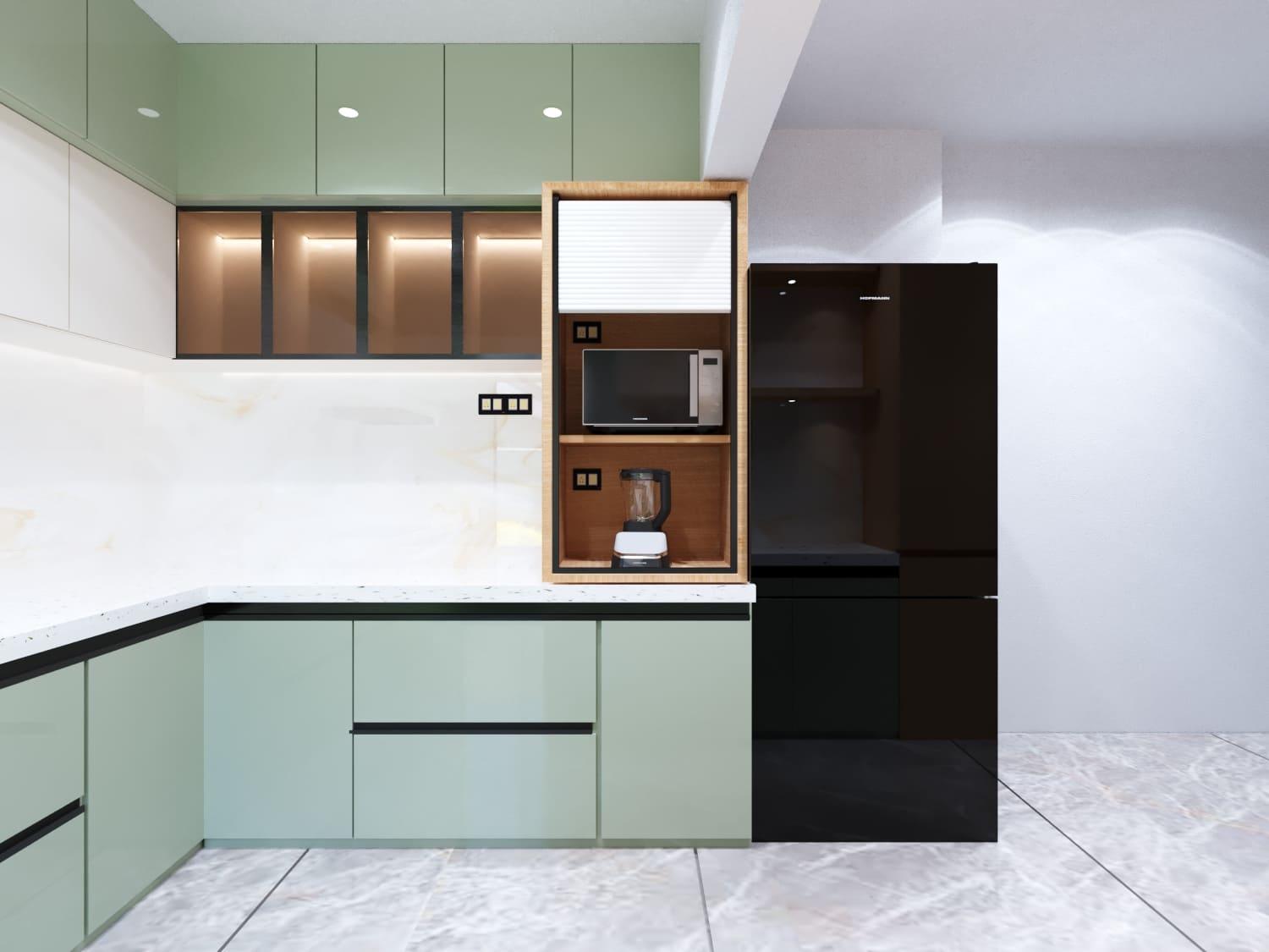 Sage-green L-shaped kitchen with a tall appliance unit, microwave niche and black fridge