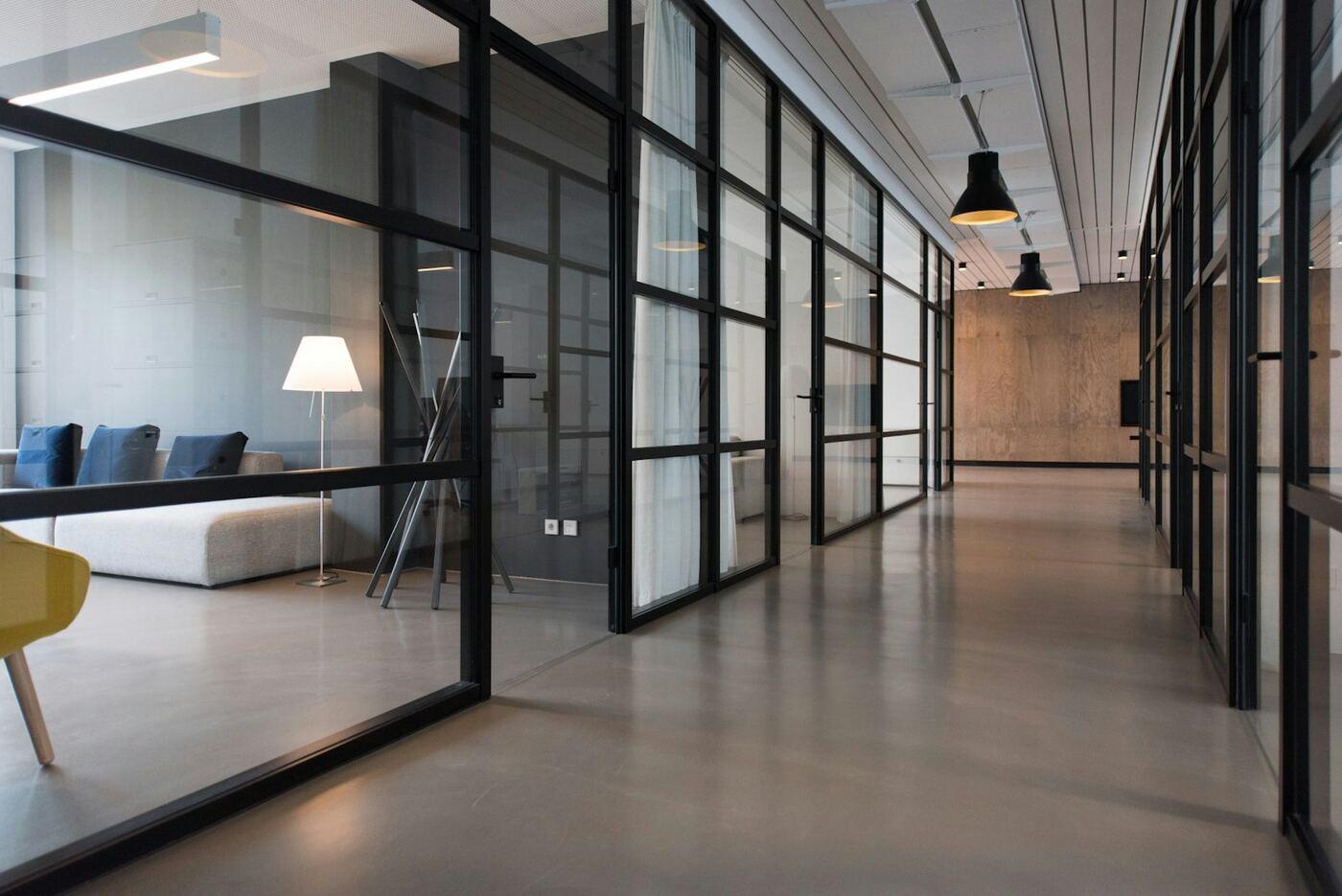 Office corridor with glass-walled cabins