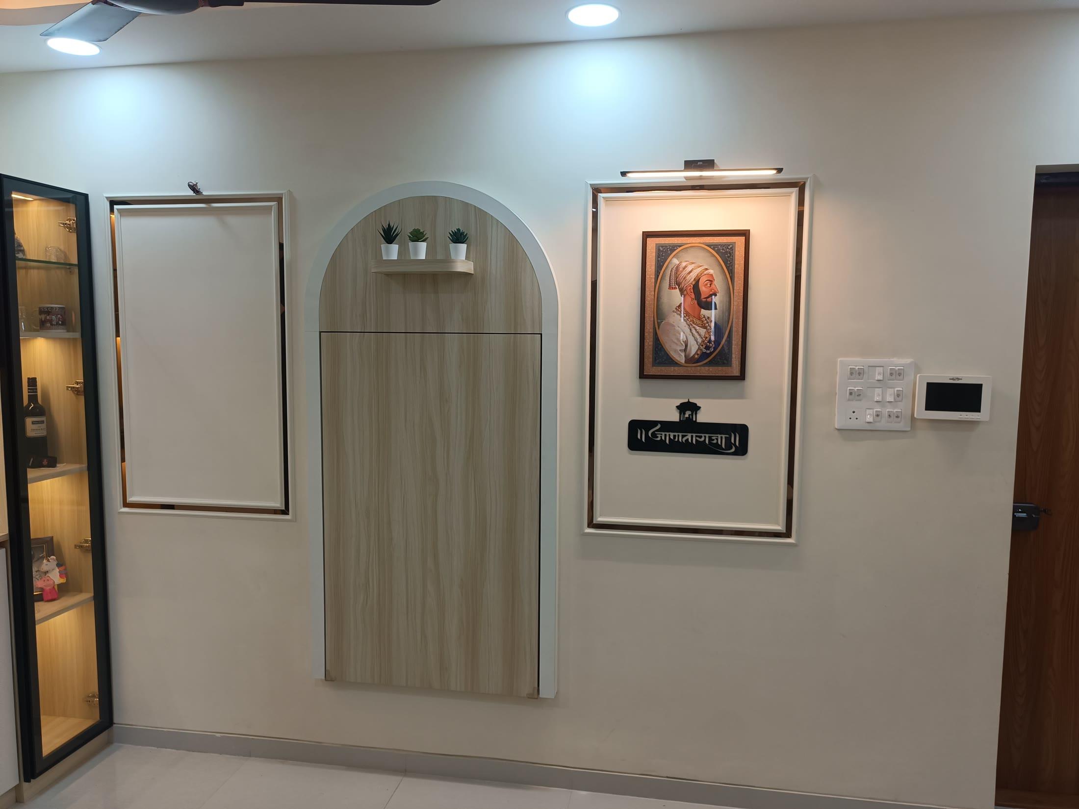 Dining wall elevation with an arched wooden niche and framed artwork