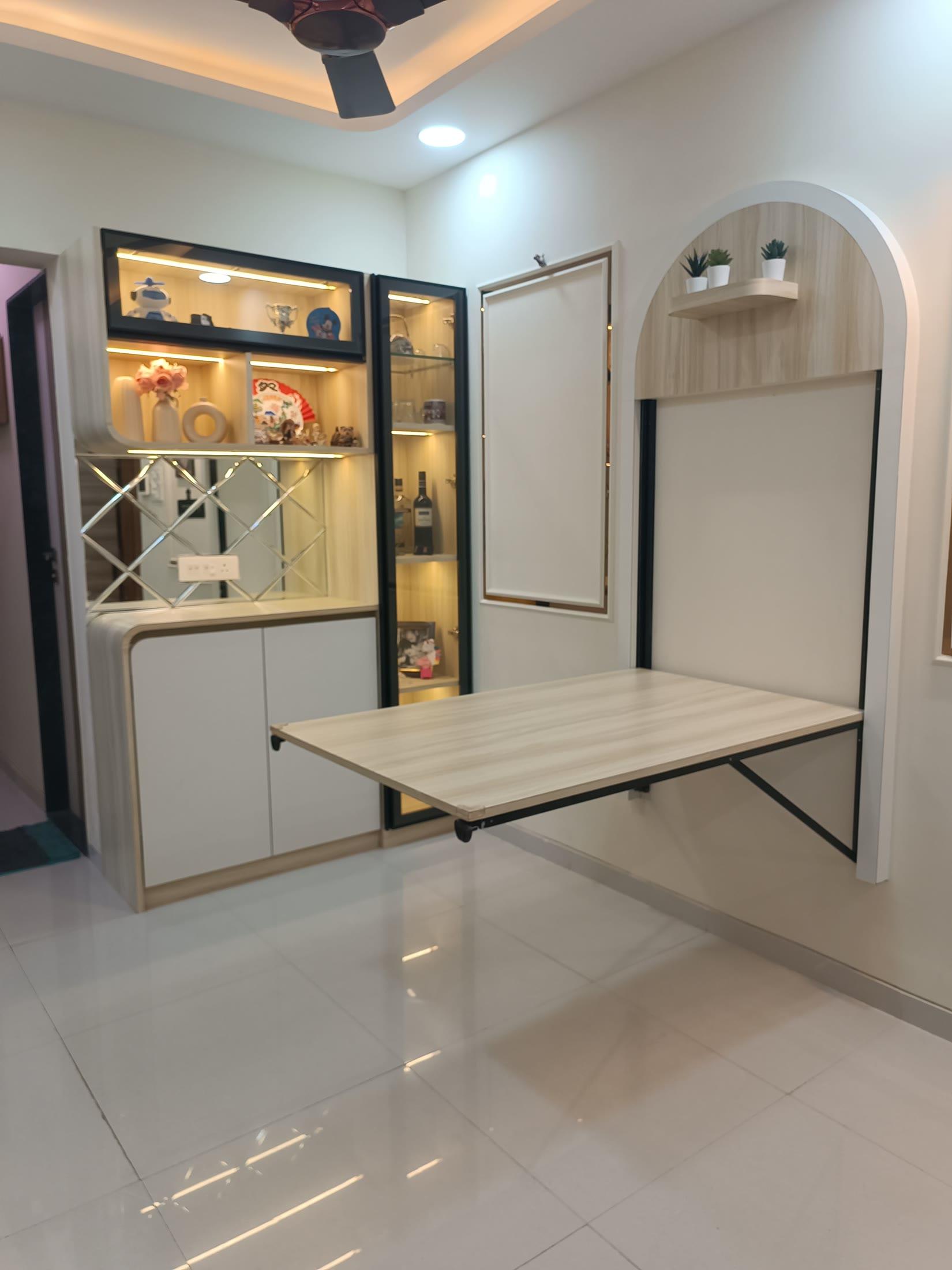 Dining corner with a wall-mounted folding table beside the display unit