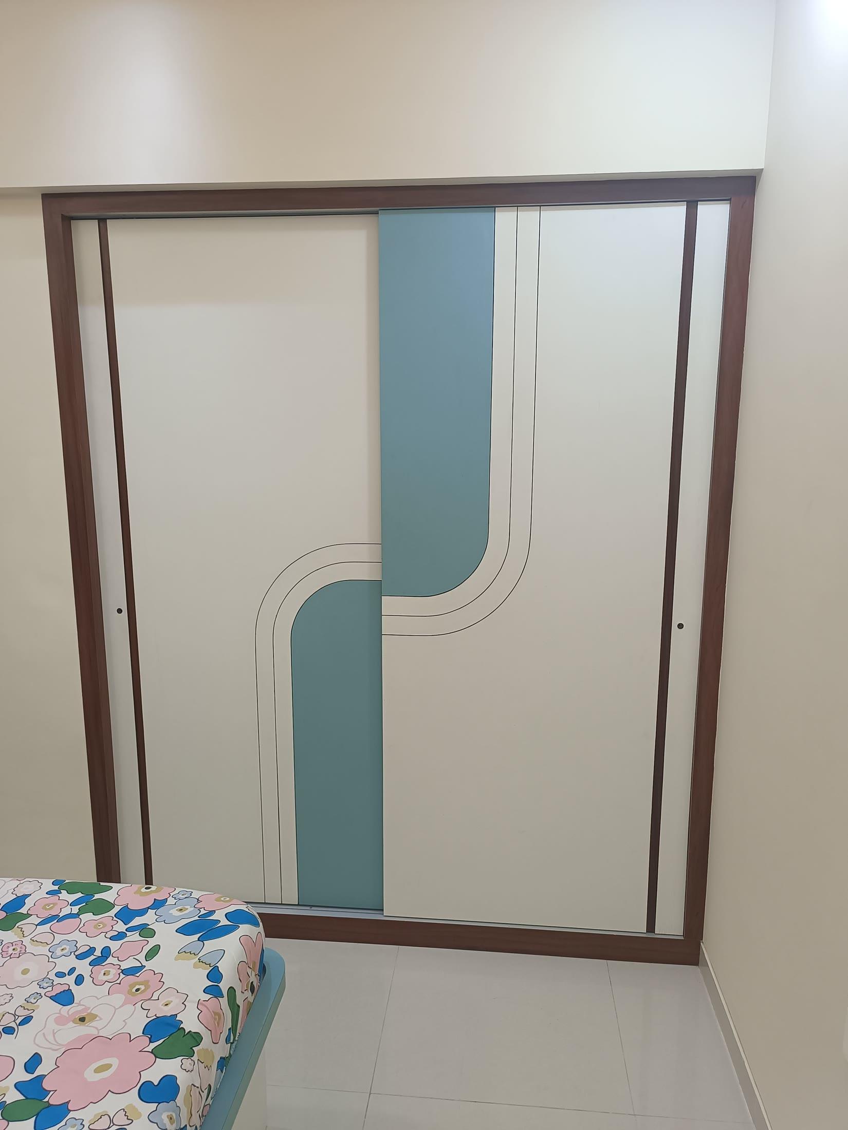 Sliding wardrobe with a curved teal inlay set in a teak frame