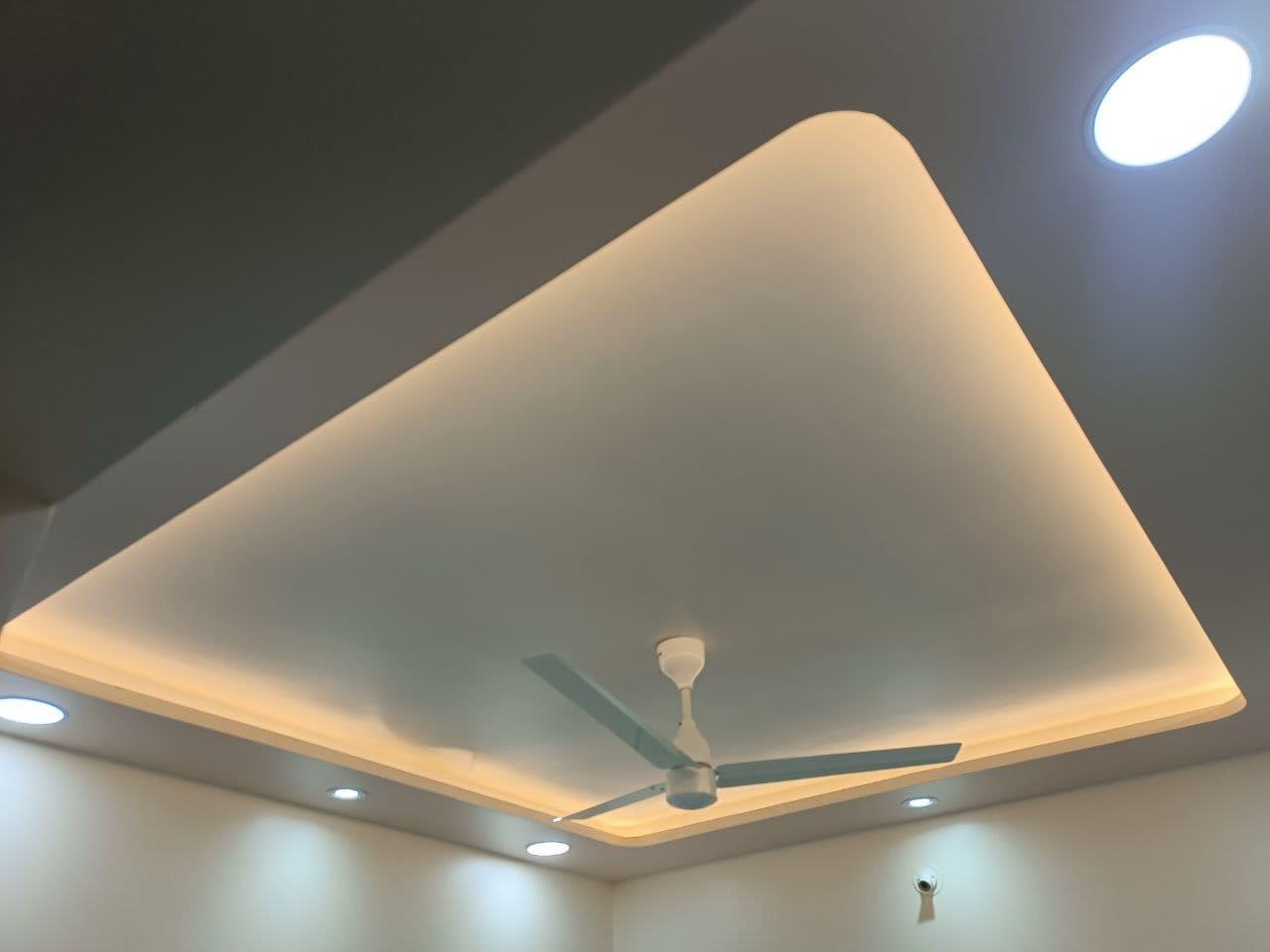 Cove-lit false ceiling detail seen from the dining side