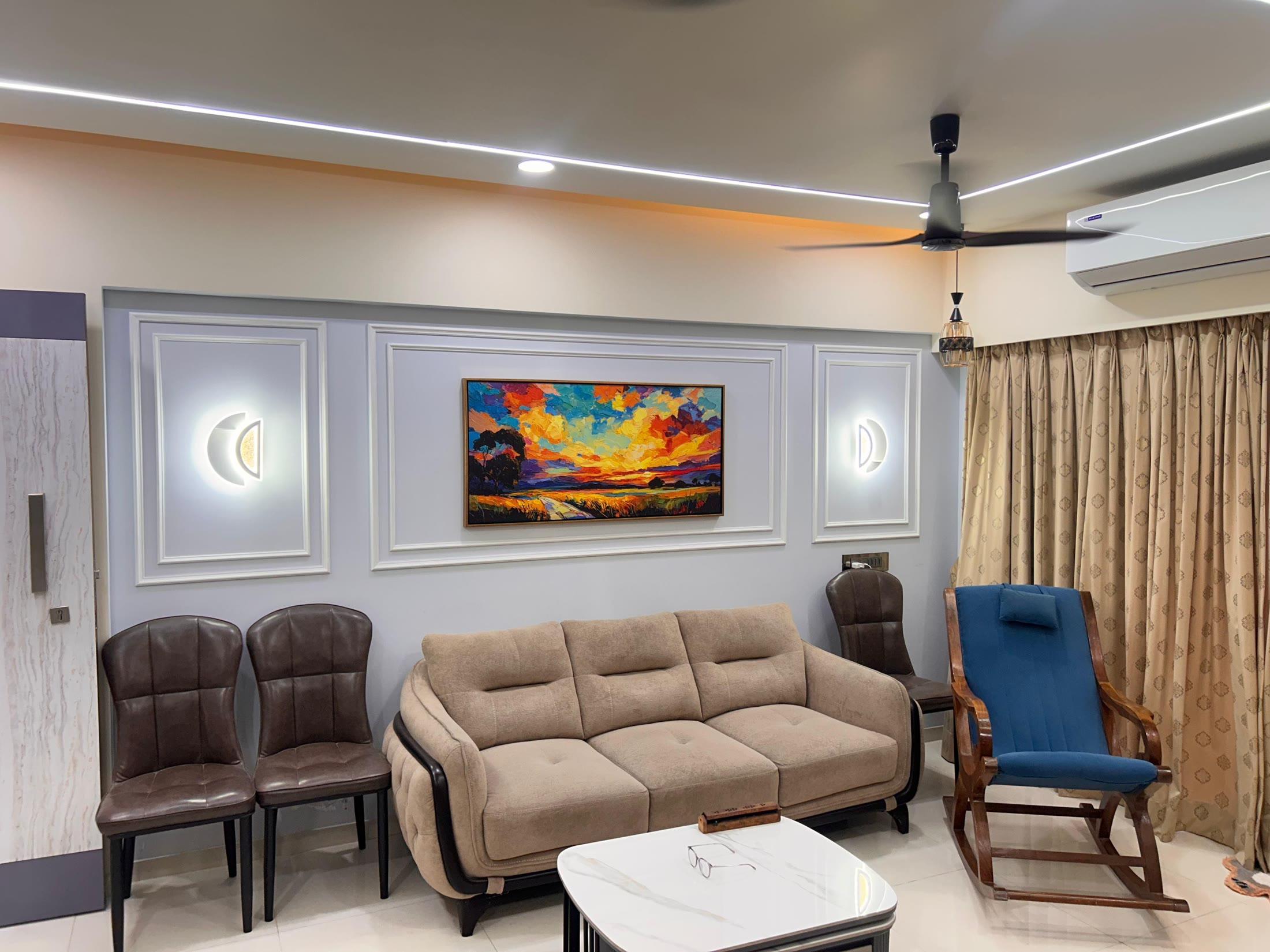 Living room with half-moon sconces flanking the artwork above the sofa