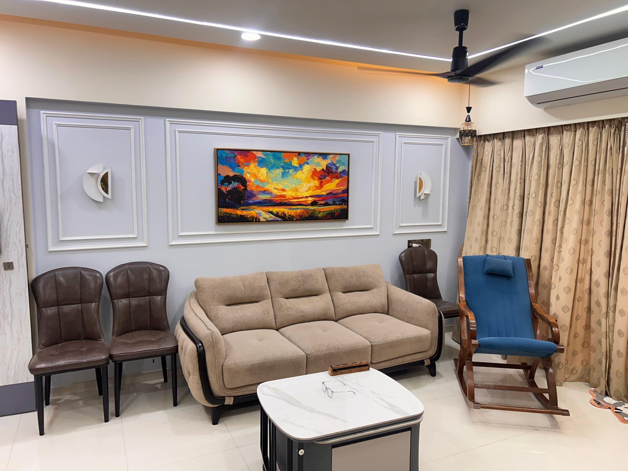 Living room seen from the dining side, with leather chairs and a marble-top table