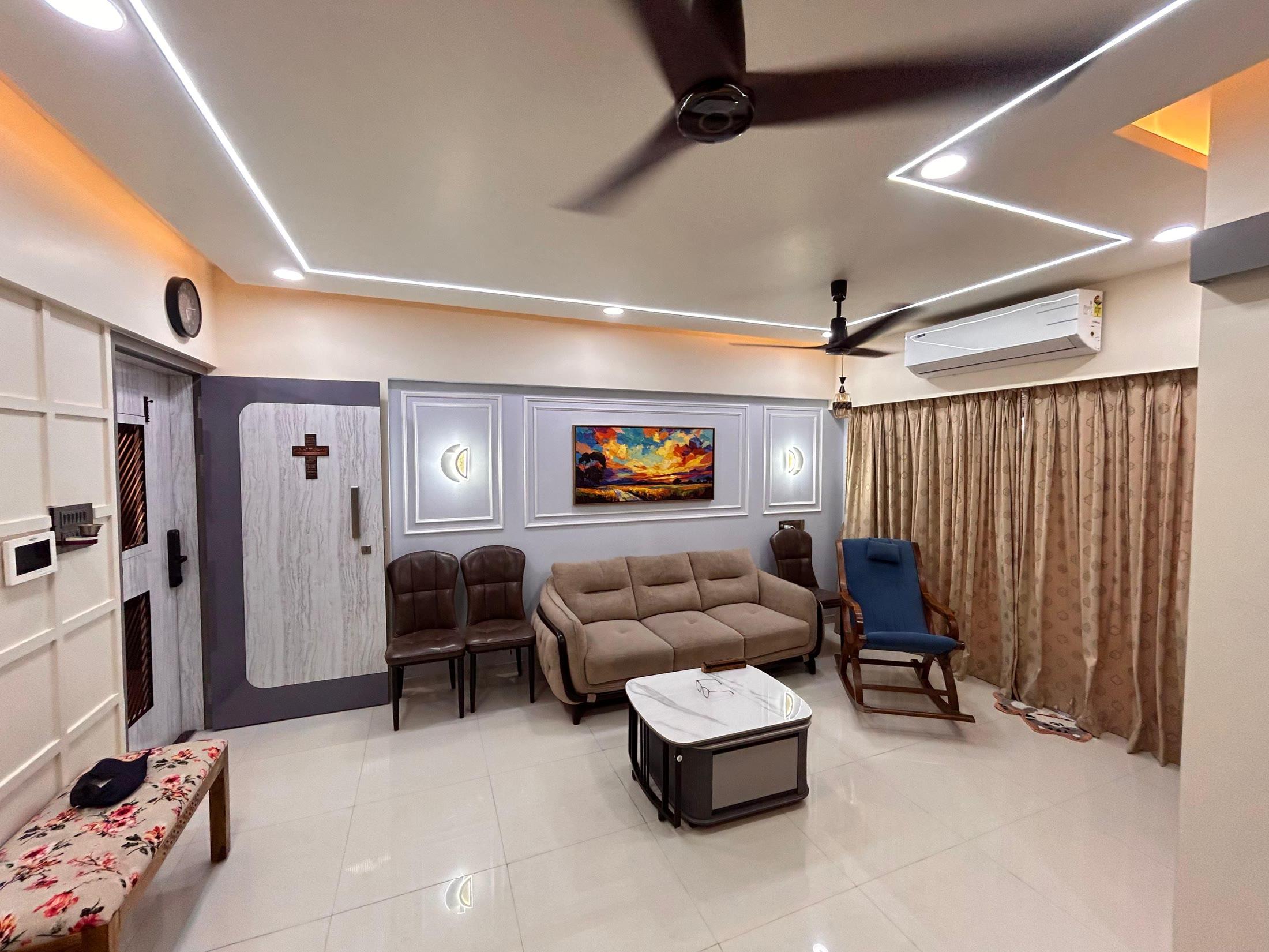 Wide view of the living room under a cove ceiling with linear lighting