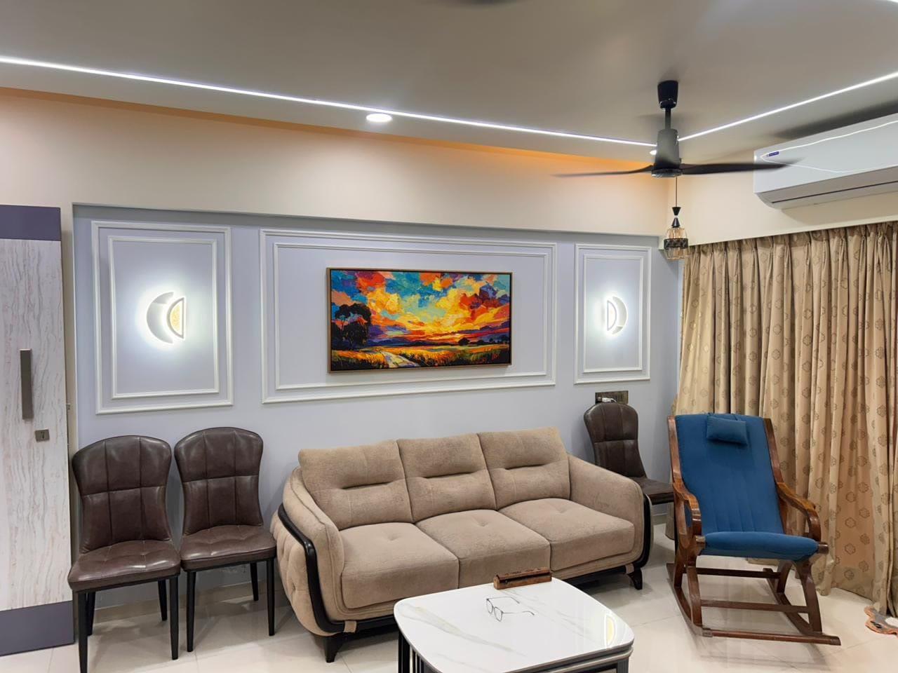 Panelled feature wall with artwork, sconces and the seating arrangement