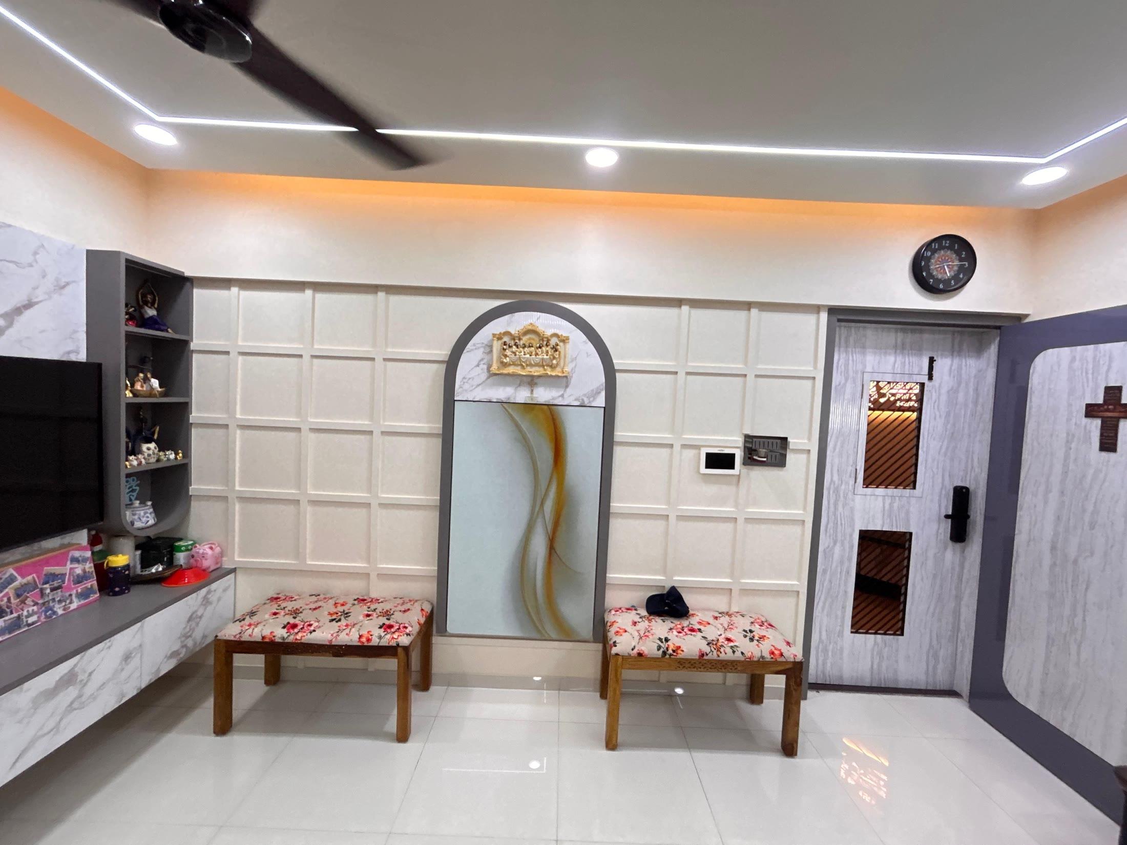 Dining side with a marble-topped lowboard, arched mirror niche and wall clock