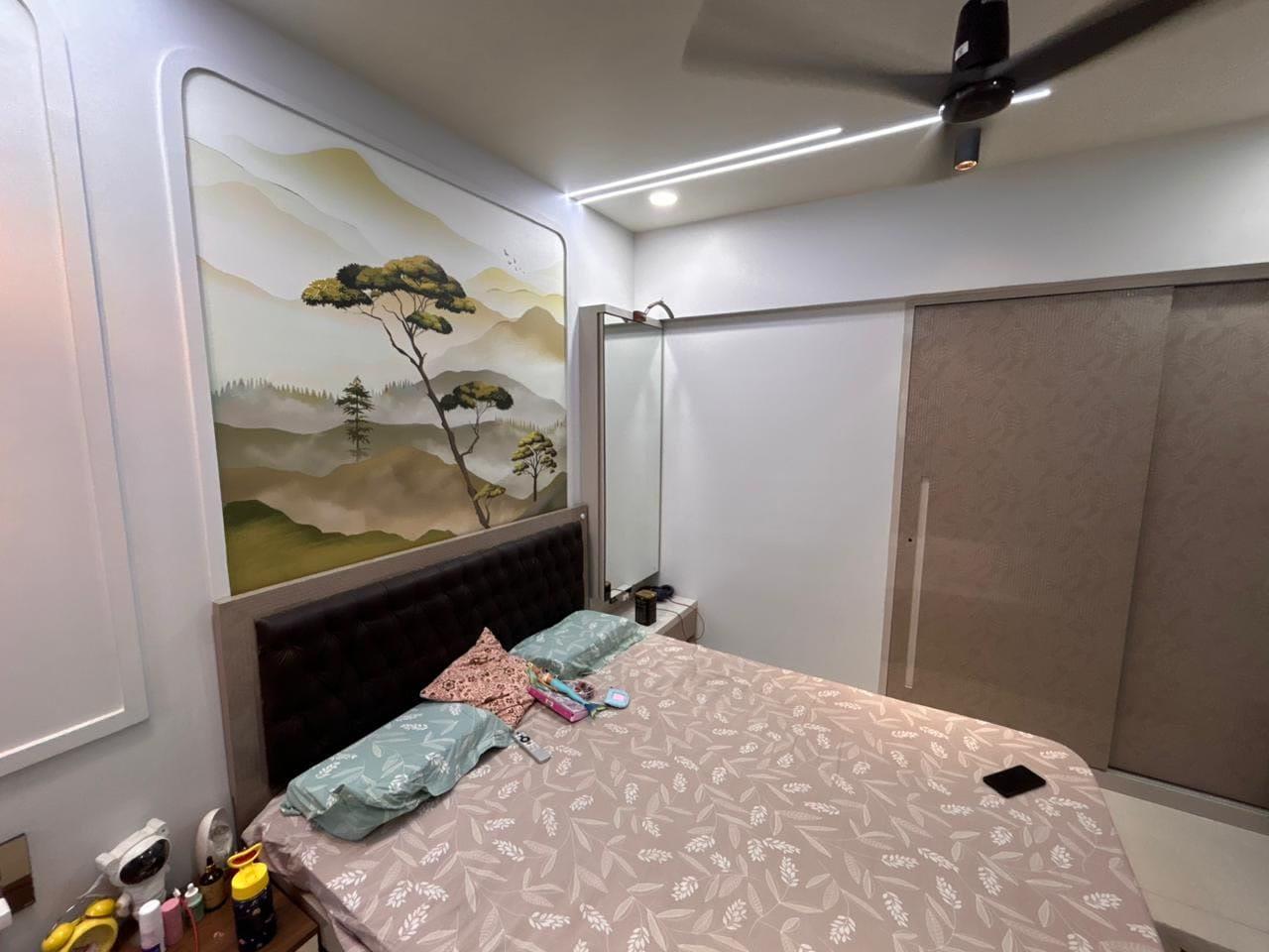 Bedroom with the sliding wardrobe alongside the muralled headboard wall