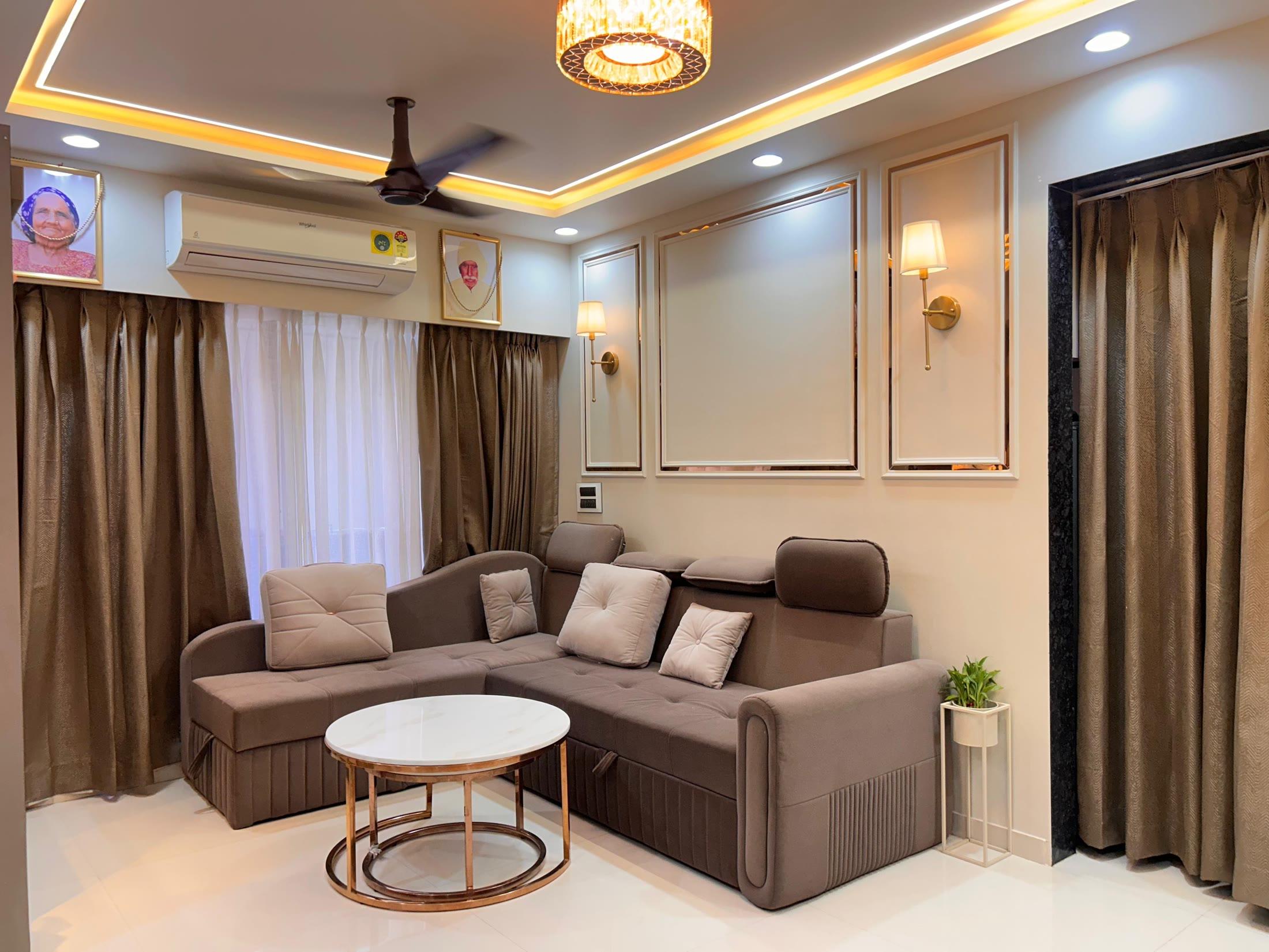 Wide view of the living room with gold sconces and floor-length curtains