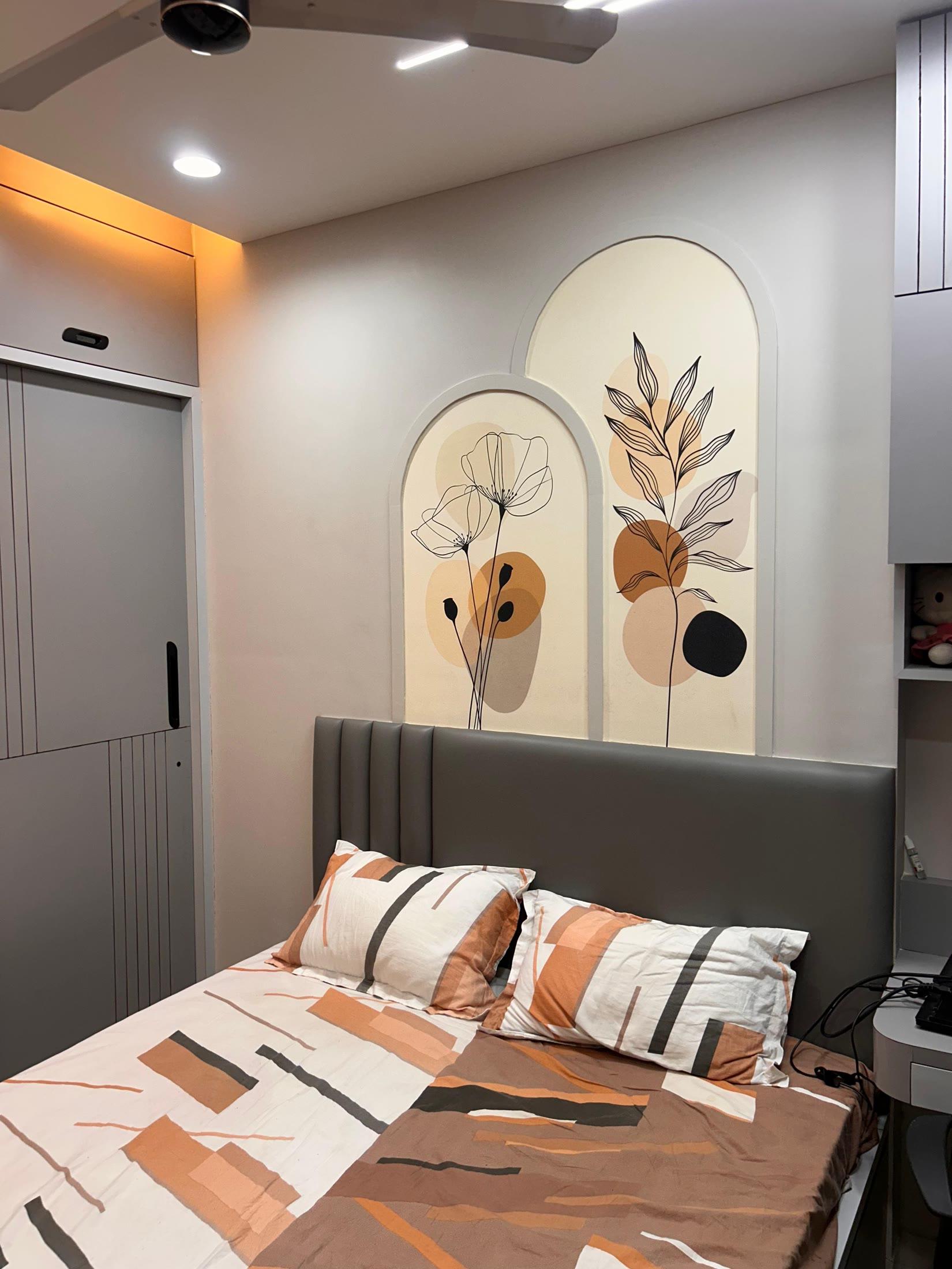 Bedroom with arched botanical panels above a fluted grey headboard