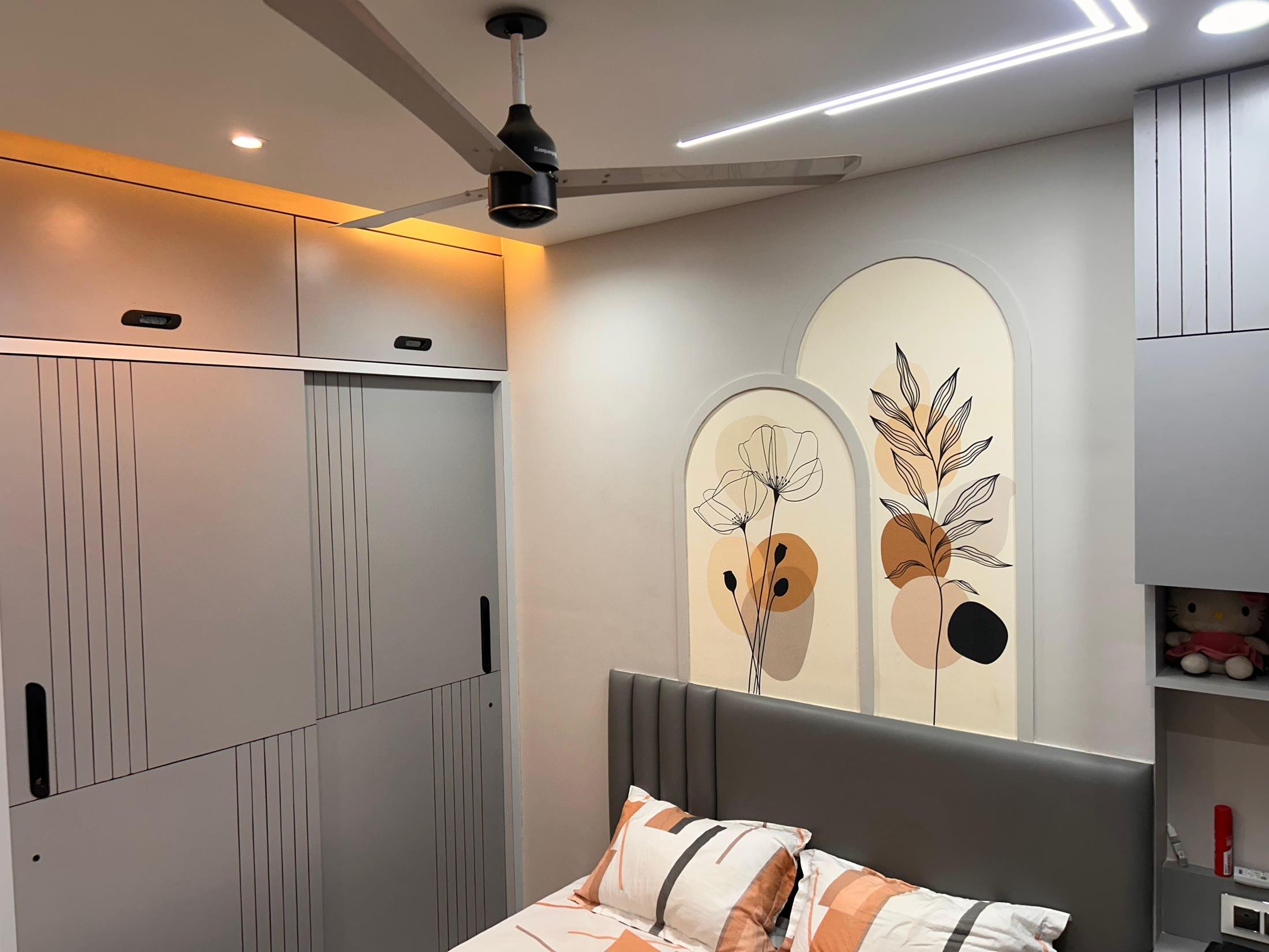 Bedroom with sliding wardrobes beside the arched wall panels
