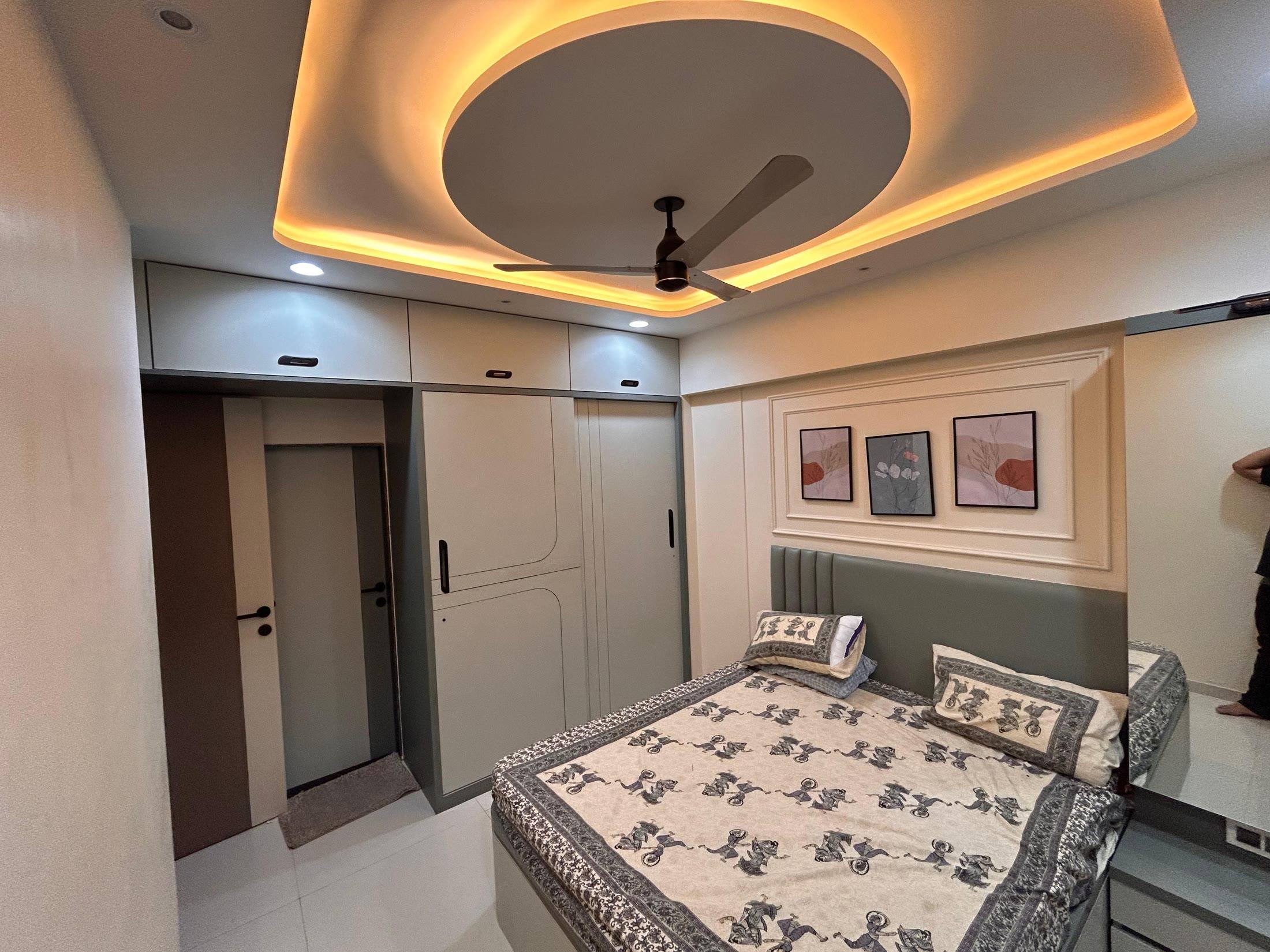 Second bedroom with a circular ceiling cove and a trio of framed prints