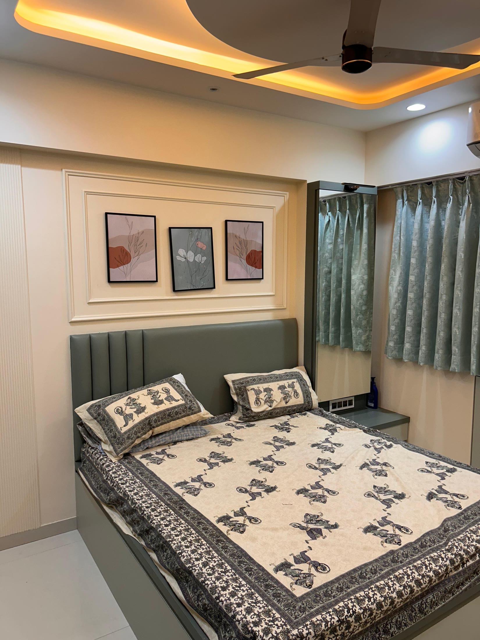 Second bedroom with a sage upholstered headboard and sheer curtains